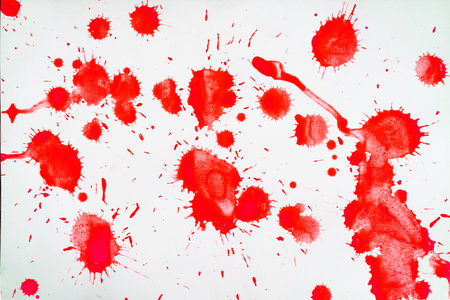 Red blots and spots on a white background.