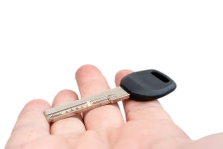 Metal door key in a man's hand. Sale and rental of real estate.の写真素材