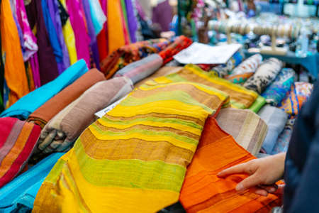 Sale of multi-colored fabrics at the fair. Retail trade in the store.の写真素材