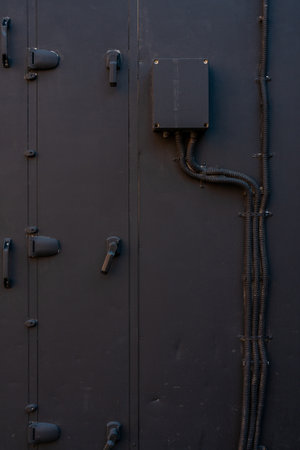 Switch box. Black paint surface. Insulated electrical wires.の写真素材