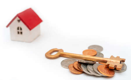 House with a red roof and a key. Sale and rental of real estate.の写真素材