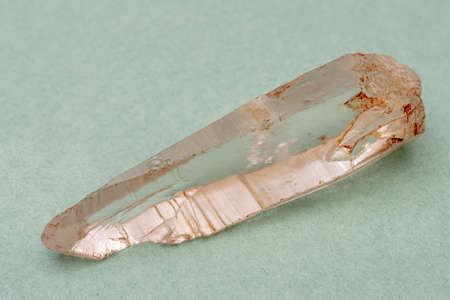 Mountain quartz crystal on a green background. Mineralogy object.の写真素材