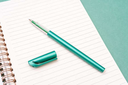 Green fountain pen and notepad pages. Preparing for scholarship and education. The torment of creativity.の写真素材