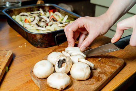 Cutting champignons. Fresh chopped vegetables and champignons. Healthy food and healthy lifestyle.の写真素材
