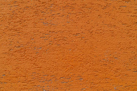 Orange plaster wall of a building. Rough surface texture.の写真素材