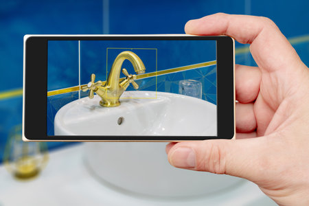 Water tap on smartphone screen. Water tap and sink in the bathroom. The interior of the living quarters.の写真素材