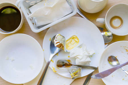 Dirty dishes on the table. Household waste is harmful to the environment.