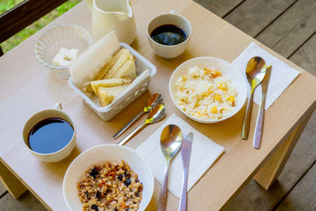 Porridge and coffee for breakfast. Light breakfast on the veranda.の写真素材
