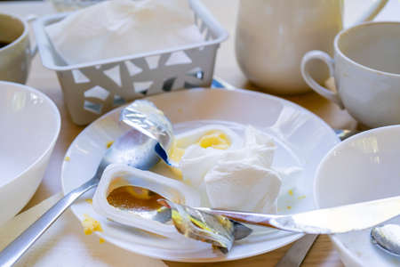 Dirty dishes on the table. Household waste is harmful to the environment.の写真素材