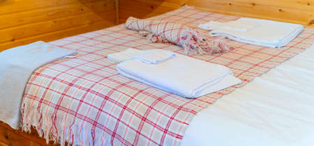 Linen on the bed in the hotel. Towels on the bed.の写真素材