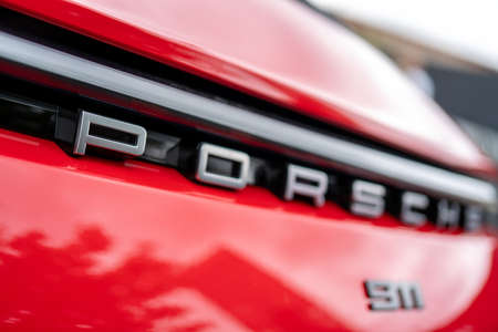 Moscow. Russia. August 13, 2021. Porsche branding on the front of a red Porsche car.のeditorial素材