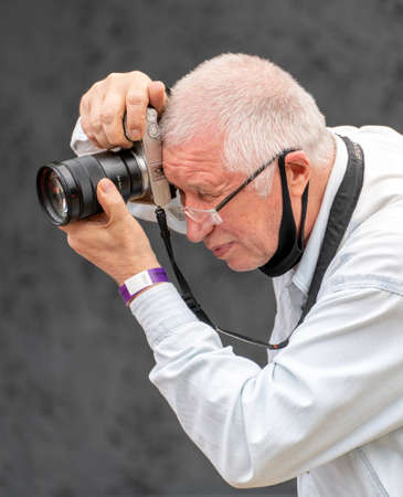 Moscow. Russia. August 13, 2021 Photographer holds a Samera in his hands. Reportage photography.のeditorial素材
