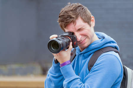 Moscow. Russia. August 13, 2021 Photographer holds a Samera in his hands. Reportage photography.のeditorial素材