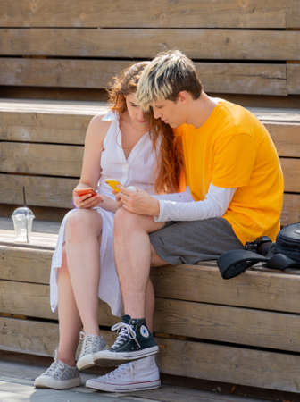 Moscow. Russia. August 14, 2021. A guy and a girl with a smartphone are looking at the screen.のeditorial素材