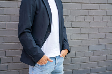 White guy in a white T-shirt and jacket. Male model against the background of the wall.の写真素材