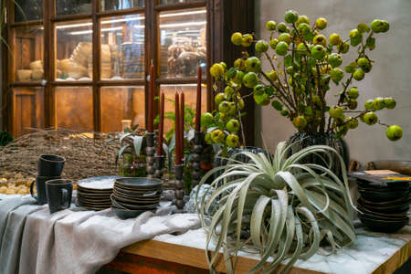 Christmas room interior. Dishes and plants on the festive table.の写真素材
