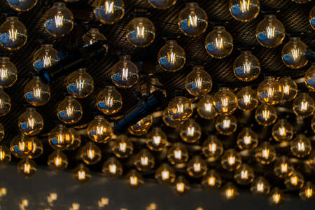 Glowing yellow light bulbs on the ceiling.の写真素材