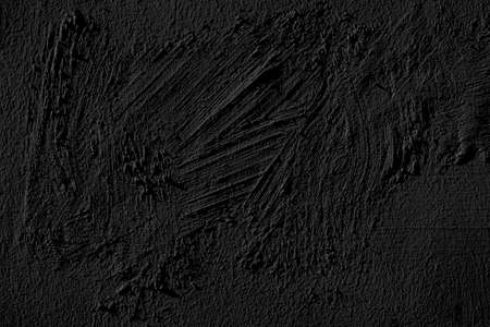 Black grungy wall plaster texture.の写真素材