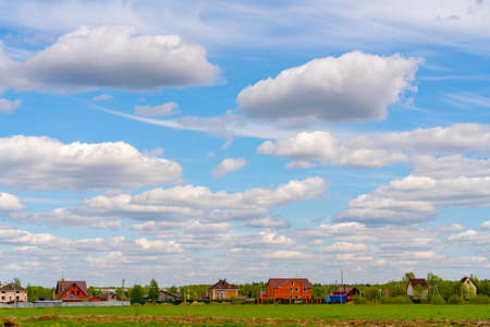 Beautiful white clouds on a bright blue background. Atmospheric weather phenomenon.の写真素材