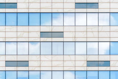 Glass facade of a modern building. Construction and rental housing.