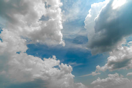 Beautiful white clouds on a bright blue background. Atmospheric weather phenomenon.