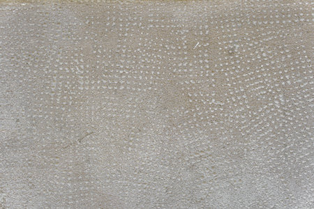 Concrete wall with traces of impacts and cracks. Abstract construction background.の写真素材