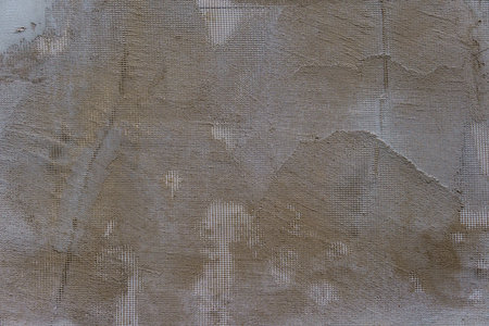 A gray wall with a white mesh pattern. The mesh is in the shape of squares.の写真素材