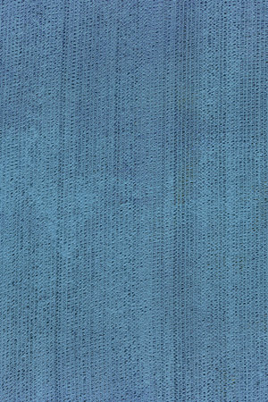 Old grid painted with blue paint. Retro industrial background.