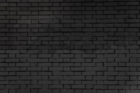 Brick wall with faded graffiti. The image captures traces of urban environment and visual aging of the surface.の写真素材