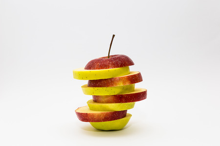Green and Red Apples Sliced Mixed Isolated on White