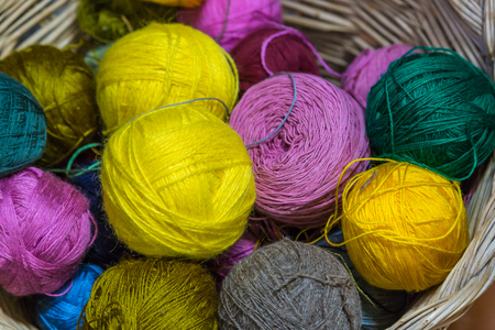 Balls of Threads and Rag Balls, Several Colors, in a Wicker Basketの写真素材