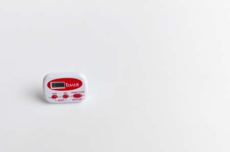 Timer, red and white, located on a white background. Useful utensil in the kitchen.の写真素材