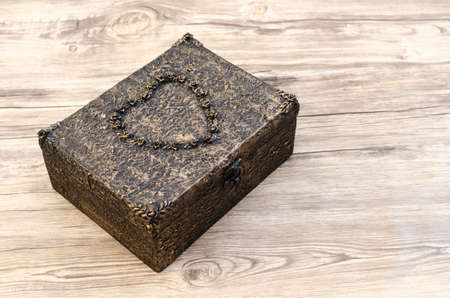 Wooden box decorated like old metal chests.