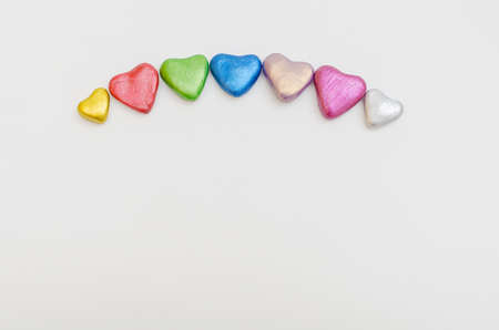 Group of hearts of different colors together on white background. Symbol of love, togethernessの写真素材