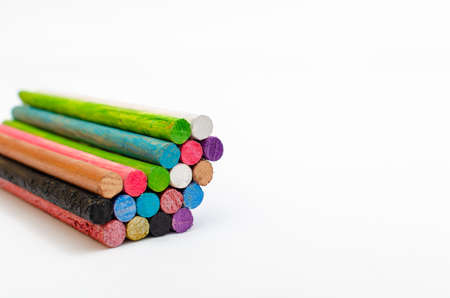 Group of colored sticks or posts forming a heart, on white background. Symbols of love and unity.