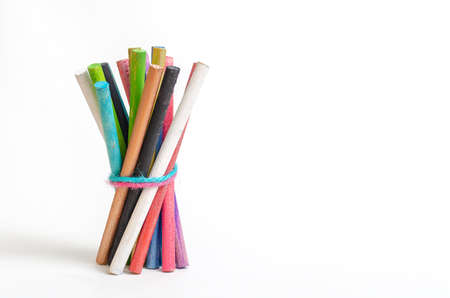 Group of colored posts or sticks of different colors, tied together.