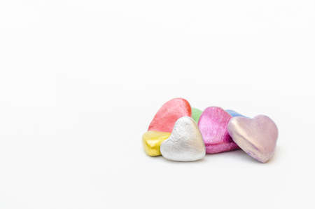 Group of hearts of different colors together on white background. Symbol of love, togethernessの写真素材