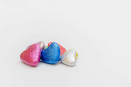 Group of hearts of different colors together on white background. Symbol of love, togethernessの写真素材