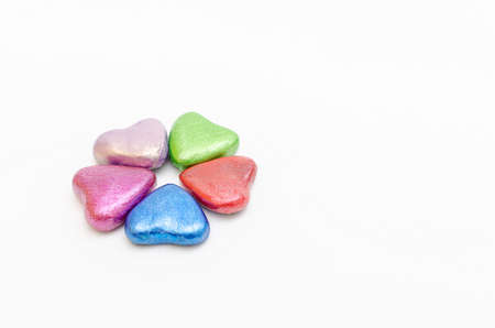 Group of hearts of different colors together on white background. Symbol of love, togethernessの写真素材