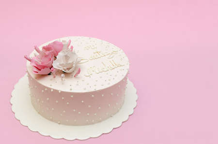 Beautiful homemade cake decorated with flowers on pink background, isolated.の写真素材