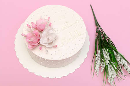 Beautiful homemade cake decorated with flowers on pink background, isolated.の写真素材