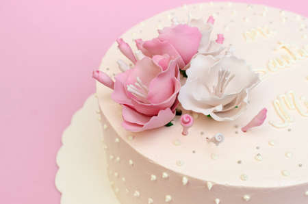 Beautiful homemade cake decorated with flowers on pink background, isolated.の写真素材