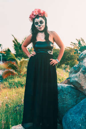 Young Mexican woman made up as a catrina on the occasion of the Day of the Dead.