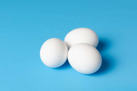 Eggs on blue background, isolated, cutout.の写真素材