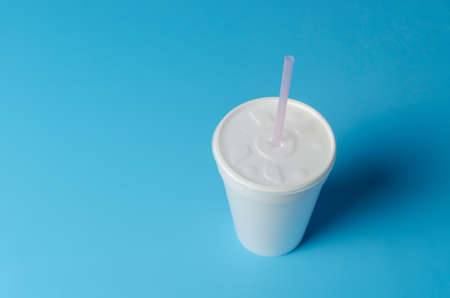 White plastic cup isolated on blueの写真素材