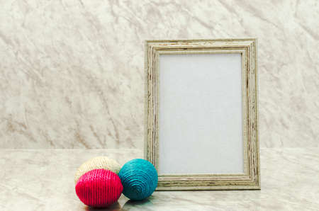 Framed greeting card on marble table with gift box aside.の写真素材