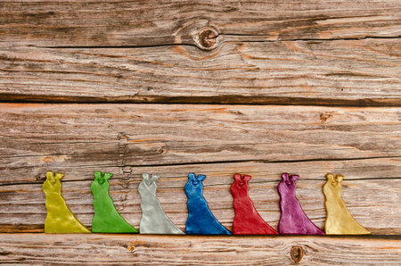 Figures of colored couples on wooden background. Symbol of love and togethernessの写真素材