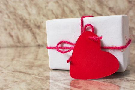Gift box with heart-shaped card. Gift for Valentine's Day.の写真素材