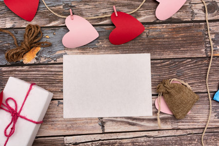 Blank card on table with craft items. Valentines Day card.の写真素材