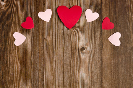Wooden background with red and white hearts. Background for Valentine's day.の写真素材